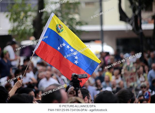 26 January 2019, Venezuela, Caracas: Numerous demonstrators raise their hands in support of the self-proclaimed interim president Guaido at a rally of the...