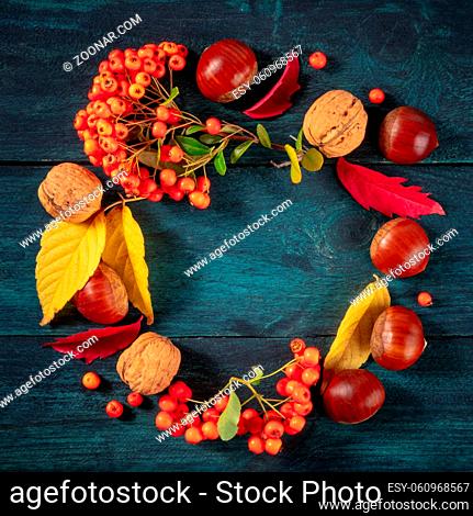 Autumn wreath, square design with a place for text, autumn leaves flatlay, overhead shot on a blue background