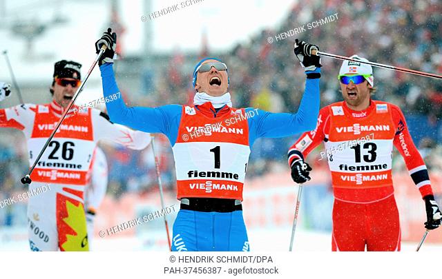 Nikita Kriukov of Russia (C) celebrates after winning the Cross Country men's 1, 5 km classic sprint at the Nordic Skiing World Championships in Val di Fiemme