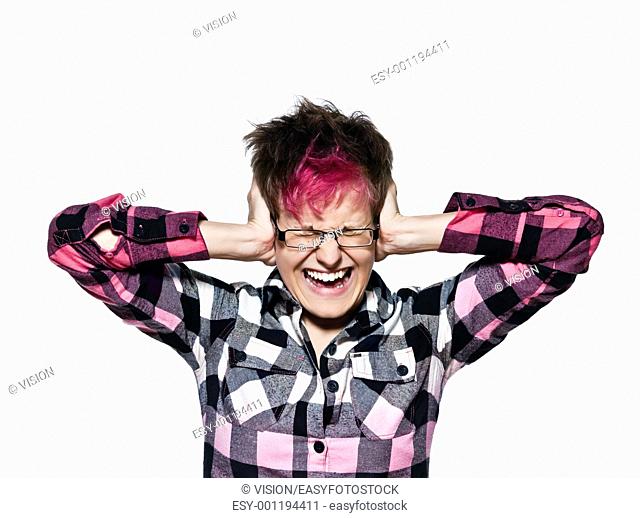 Portrait of a cool young woman screaming while covering ears isolated on white background