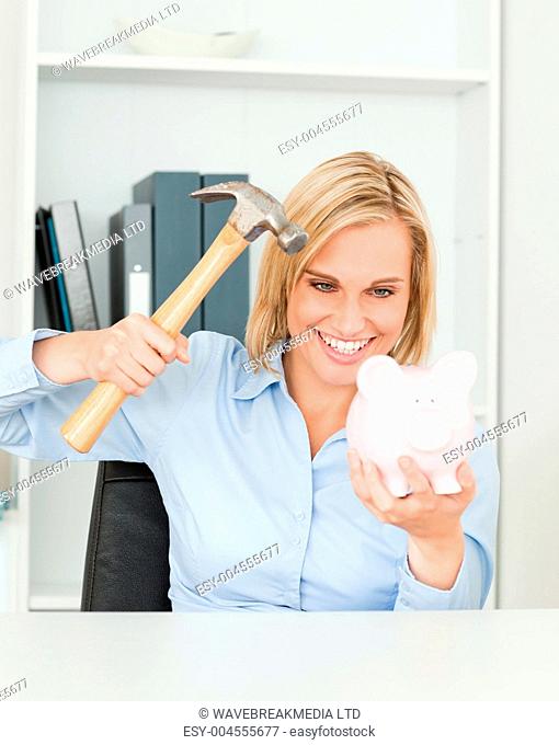 Smiling woman wanting to destroy her piggy bank