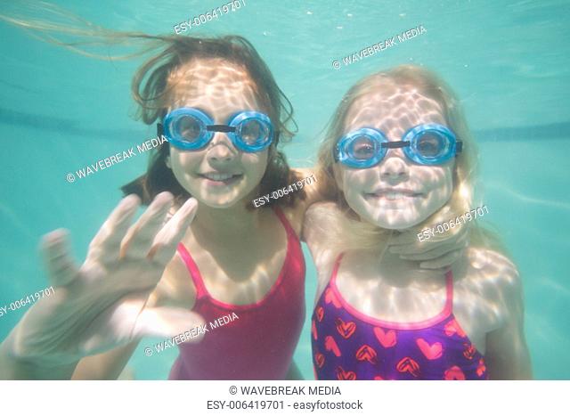 Cute kids posing underwater in pool
