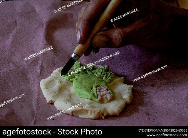 OZUMA, MEXICO - APR 25, 2022: Diego Barranco Flores during the manufacturing of handmade cookies with pre-Hispanic themes