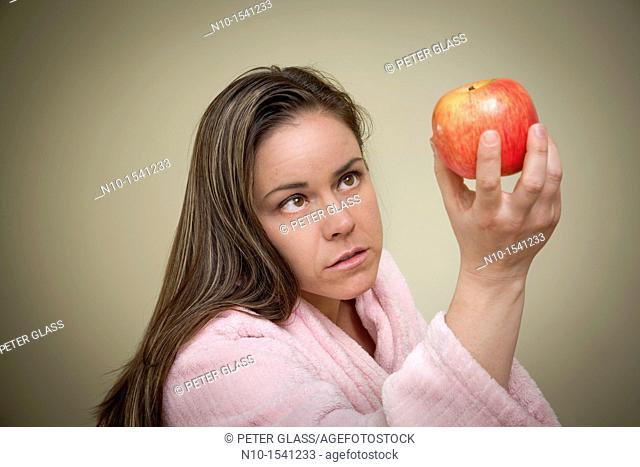 Woman examining an apple