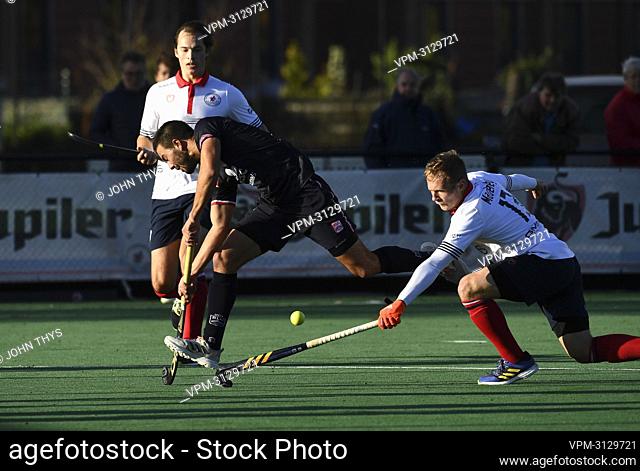 Leopold's Federico Monja and Leuven's Luke Madley fight for the ball during a hockey between Koninklijke Hockey Club Leuven and Royal Leopold Club