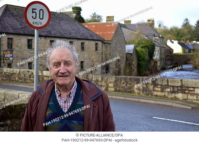 08 February 2019, Great Britain, Pettigo: Mervyn Johnston, Northern Irish car mechanic, is standing in front of the bridge that connects the Northern Irish part...