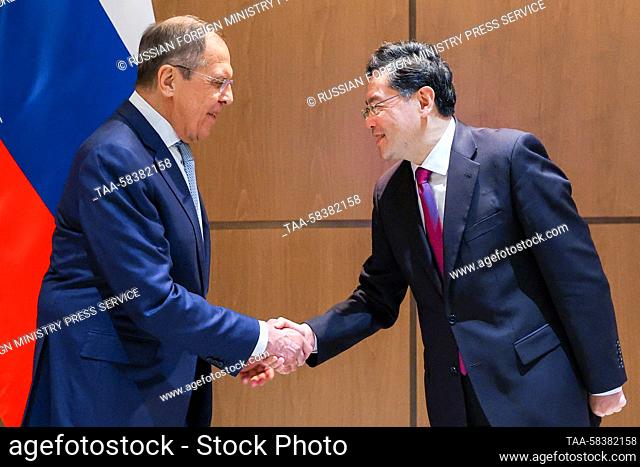 UZBEKISTAN, SAMARKAND - APRIL 13, 2023: Russia's Foreign Minister Sergei Lavrov (L) and his Chinese counterpart Qin Gang shake hands during a bilateral meeting...