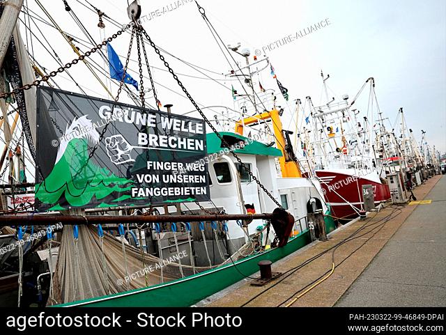 22 March 2023, Schleswig-Holstein, Büsum: A protest banner with the text ""Break the green wave - Hands off our fishing grounds"" is seen on a cutter in the...