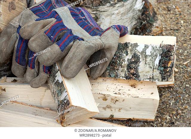 Gloves and birch firewood