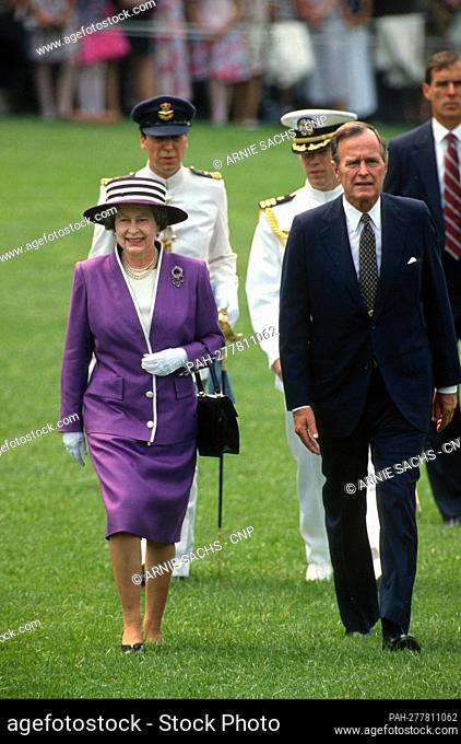 United States President George H.W. Bush, right, walks on the South Lawn with Queen Elizabeth II of Great Britain, left, as he welcomes her for a State Visit on...