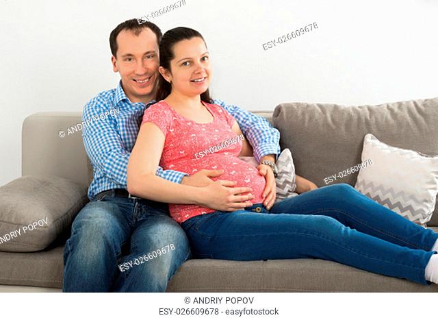 Close-up Photo Of Pregnant Couple Touching Belly