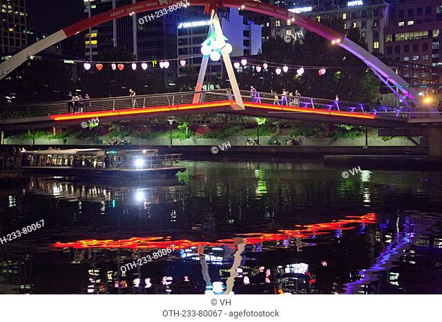 Evan Walker Bridge and the Ponyfish Island cafe underneath the bridge on Yarra River at night, Melbourne, Victoria, Australia
