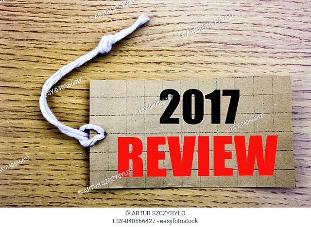 2017 Review. Business concept for online saleAnnual Summary Report written on price tag paper with copy space on wooden vintage background