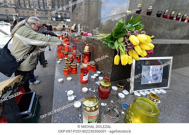 Ukrainians living in the Czech Republic pay respects to victims of the violence in Ukraine at Prague's Wenceslas Square, Sunday, Feb. 23, 2014