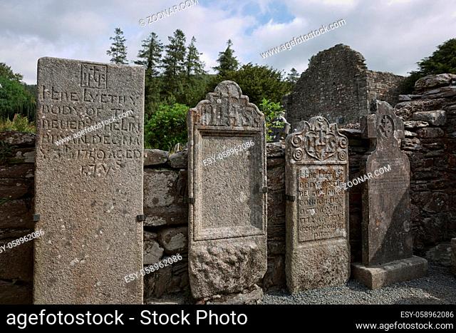 Glendalough, co. Wicklow, Ireland - August 10 2019 :Stone round tower and some ruins of a monastic settlement originally built in the 6th century in Glendalough...