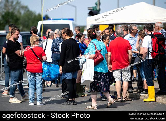 22 July 2021, North Rhine-Westphalia, Erftstadt: Residents wait at a roadblock to be allowed into their homes in the Blessem district