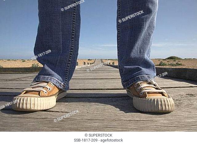 Person Standing on Boardwalk, Dungeness, UK