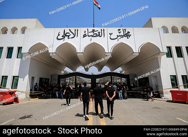 23 August 2022, Iraq, Baghdad: Supporters of Iraq's influential Shiite cleric Muqtada al-Sadr stage a sit-in in front of the Supreme Judicial Council to demand...