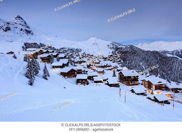 Dusk lights on the snowy alpine village surrounded by woods Bettmeralp district of Radon canton of Valais Switzerland Europe