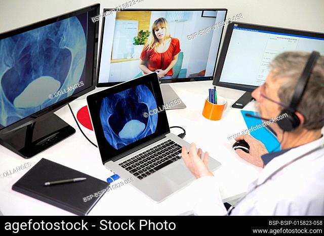 A GP during a video consultation with a woman, looking at a bladder x-ray