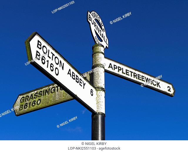 England, North Yorkshire, Burnsall. Road sign at Burnsall showing directions to Grassington, Bolton Abbey and Appletreewick