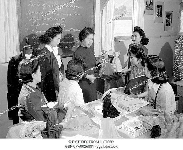 USA / Japan: Mrs. Ryie Yoshizawa, teacher, fashion designing class. Manzanar Japanese American Internment Camp, Ansel Adams, 1943