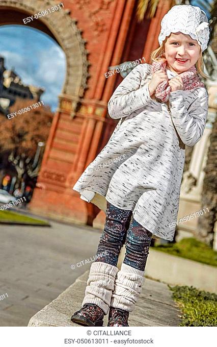in Barcelona for a perfect winter. Full length portrait of happy trendy girl in Barcelona, Spain standing