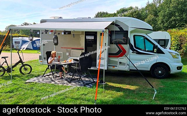 A new mobile home with awning and table and chairs