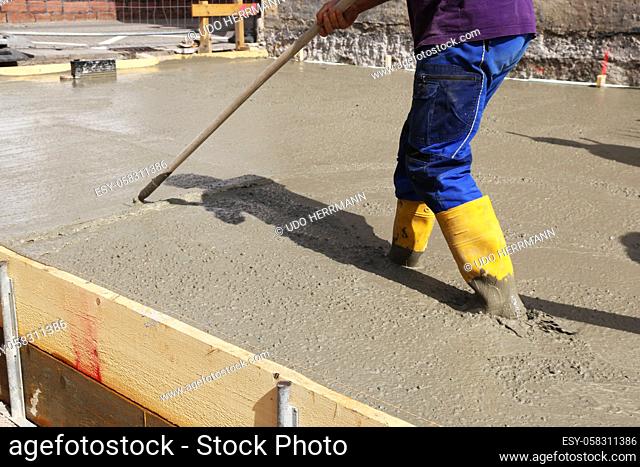 Concreting a base plate with ready-mixed concrete on the construction site of a residential building