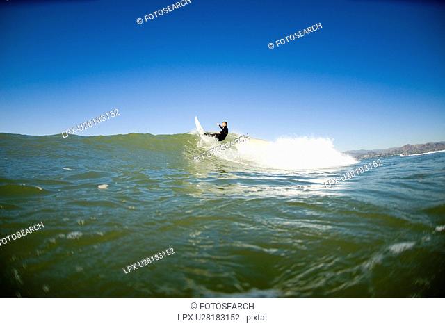 A male surfing