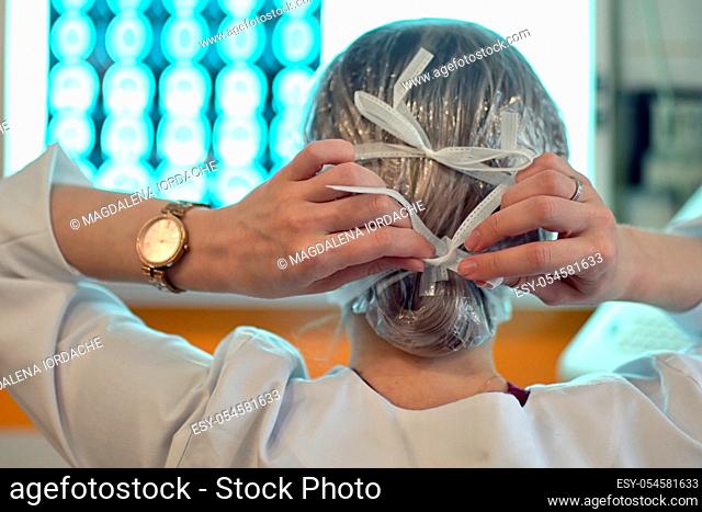Young Woman Doctor Puts On A Protective Mask