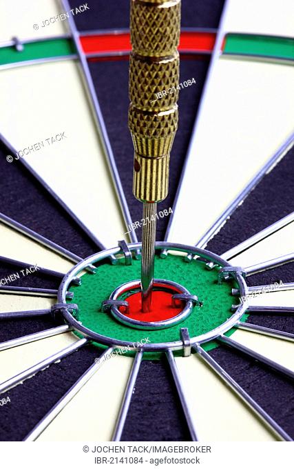 Darts, throwing game, dart sticking into the middle of the dartboard, the bullseye