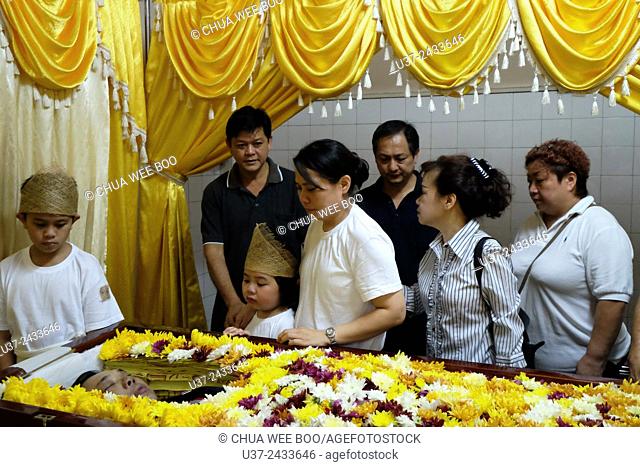 Family grieving the loved one. Sarawakian chinese funeral ceremony. Malaysia