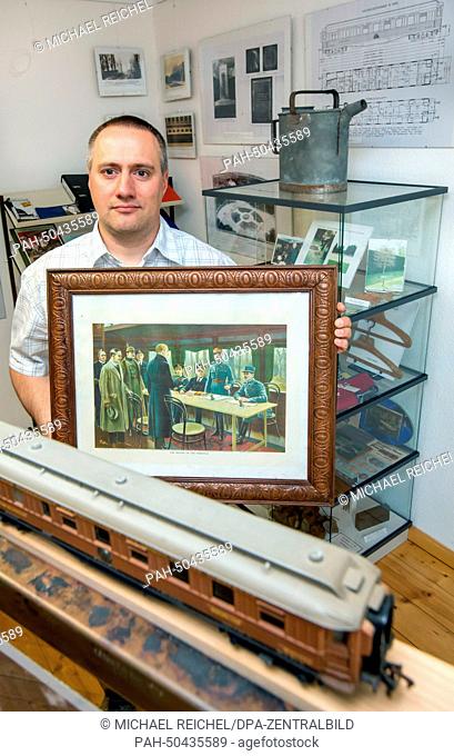 Chairman of the society 'Alte Muehle' (lit. old mill), Klaus-Peter Schambach, presents the collection of historic pictures and remnants of the legendary 'Wagon...