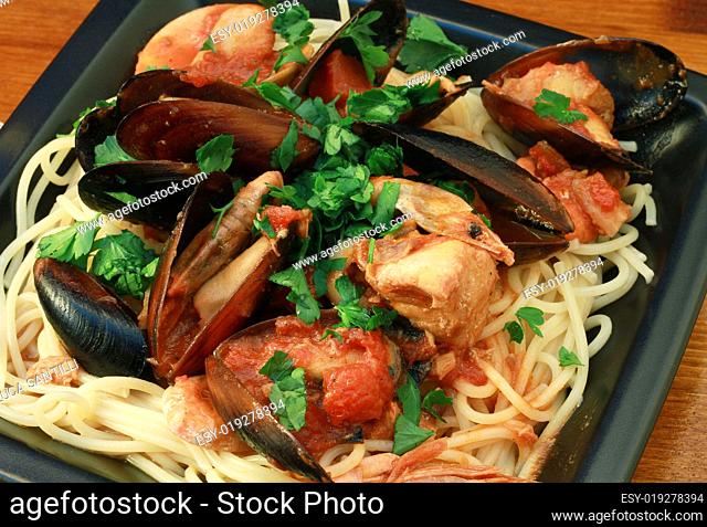 photo of delicious pasta with clams and mussel