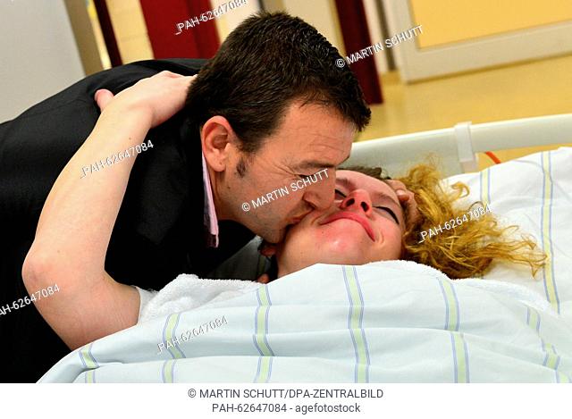 Mother of the quadruplets, Oltjana Koci, gets a kiss from their father Vebi Keta at the Universitaetsklinikum hospital in Jena, Germany, 16 October 2015