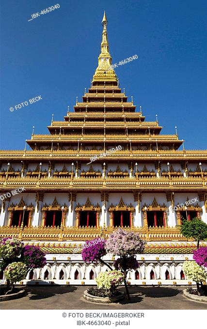 Flowering bushes in front of nine-story stupa Phra Mahathat Kaen Kakhon, Wat Nong Waeng Temple, Khon Kaen, Isan, Thailand