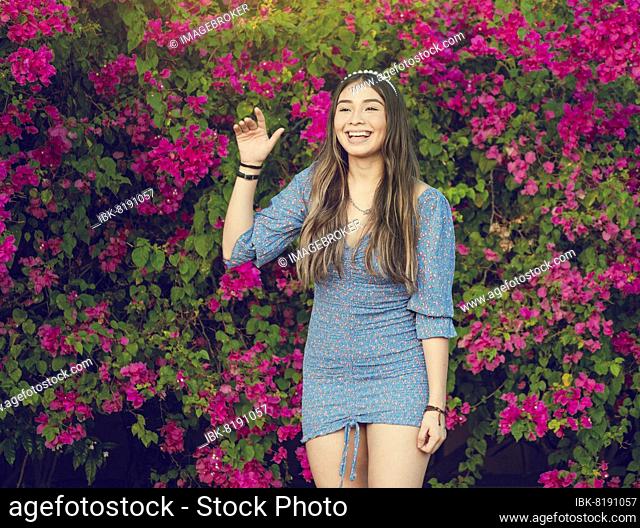 Portrait of a cute latin american girl smiling in a garden, cute young brown latin girl smiling in garden