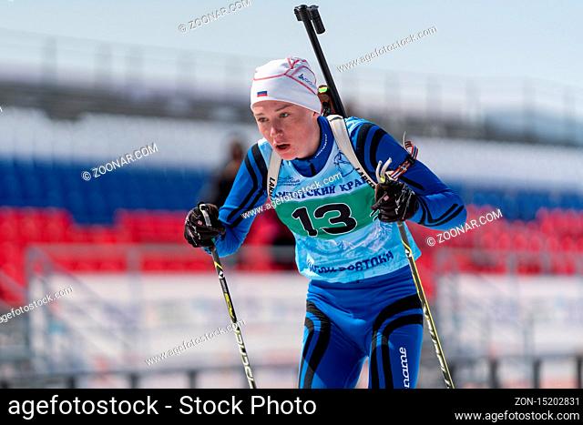 Sportsman biathlete Protasov Dmitry skiing on ski track distance biathlon stadium during Junior biathlon competitions East Cup