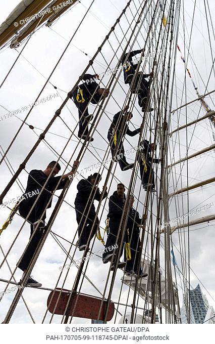 Sailors climb down the masts after the Argentinian training sailing ship 'Libertad' moored at the Ueberseebruecke (lit. overseas bridge) at the Landungsbruecken...