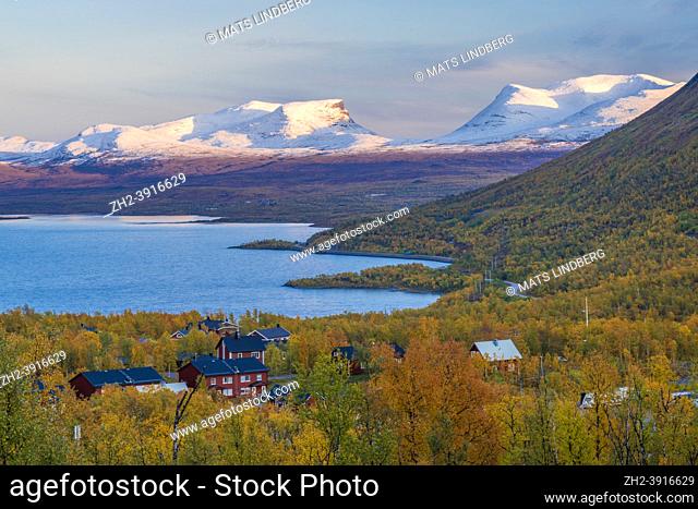 Abisko with Laporten in autumn season with snow on the mountain and colorful birch trees and lake Torneträsk, shot from Björkliden, Swedish Lapland, Sweden