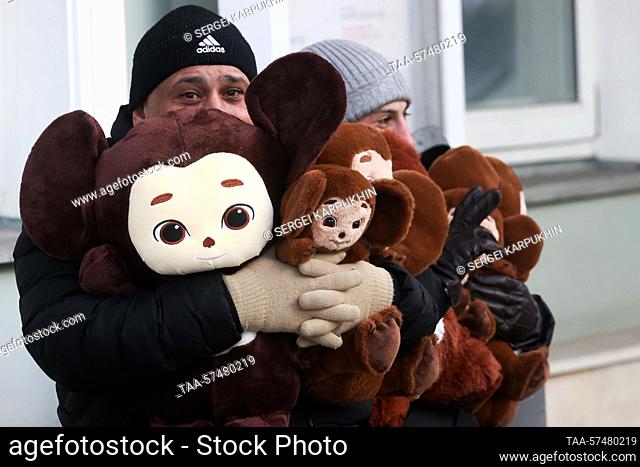 RUSSIA, MOSCOW - FEBRUARY 21, 2023: A man holds an armful of Cheburashka stuffed toys. Sergei Karpukhin/TASS