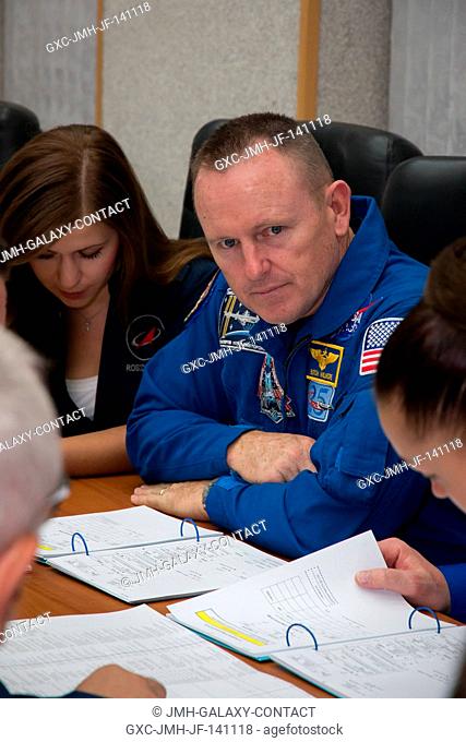 At the Cosmonaut Hotel crew quarters in Baikonur, Kazakhstan, Expedition 41 Flight Engineer Barry Wilmore looks on intently as he and his crewmates review...
