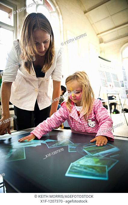 Mother and child using a table-top touch screen display in the science pavilion at the National Eisteddfod of Wales, Ebbw Vale 2010