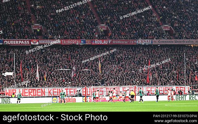 17 December 2023, Bavaria, Munich: Soccer: Bundesliga, Bayern Munich - VfB Stuttgart, matchday 15, Allianz Arena. Munich's Fasn protest with a banner reading...