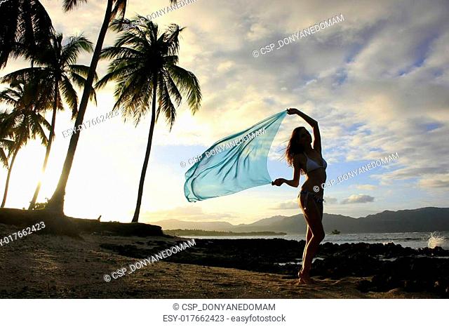 Silhouette of young woman standing at Las Galeras beach