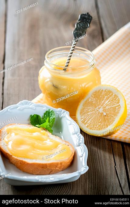 Homemade lemon curd on the toast and in a jar