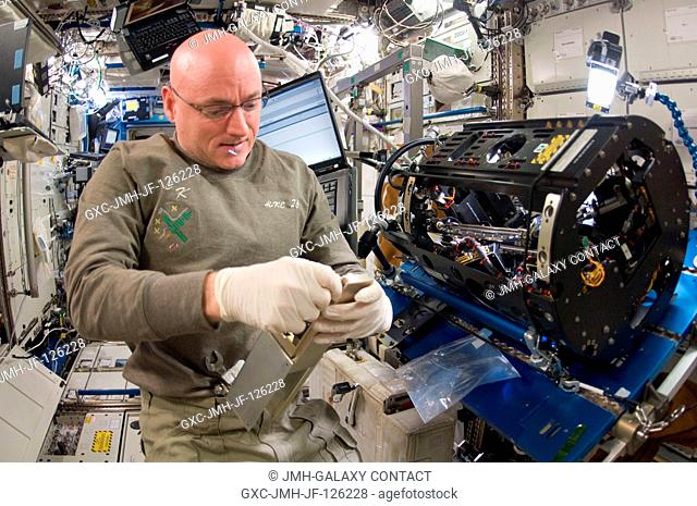 NASA astronaut Scott Kelly, Expedition 26 commander, works on the Combustion Integrated Rack (CIR) Multi-user Drop Combustion Apparatus (MDCA) in the Destiny...