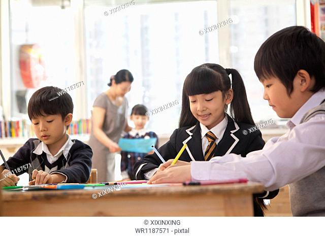 School children drawing during art class, Beijing