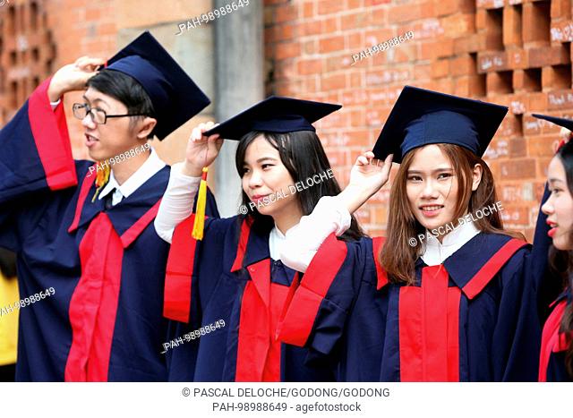 Group of Young Asian university students wearing cap and gown. Ho Chi Minh City. Vietnam. | usage worldwide. - Ho Chi Minh City/Vietnam